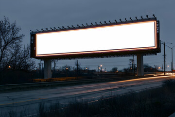 Wide rectangular backlit billboard on a highway overpass, blank for automotive ads.