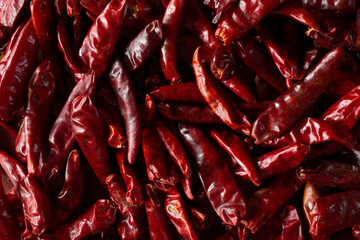 A top down view of a layer of chile de arbol, as a background.