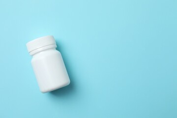 White bottle on color  background, top view