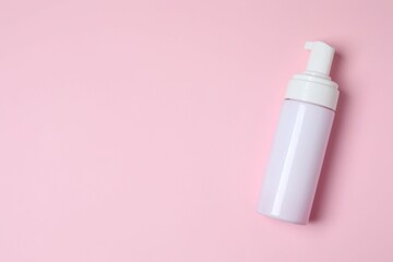 Natural cosmetic products. Cosmetic bottle on a pink background, top view