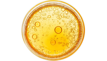 Drop of yellow oil swatch texture in petri dish macro with bubbles, cosmetics for face and body, science, laboratory isolated on white background