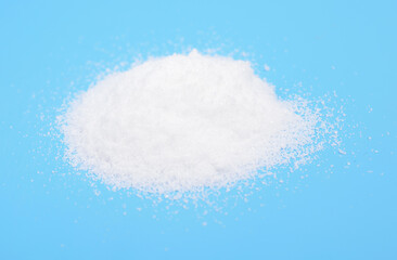 Thiourea powder on blue background.