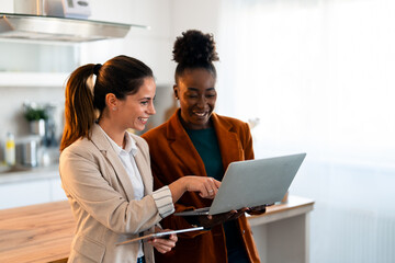 Professional Women From Different Ethnicities Working Together On Computer Project In Bright...