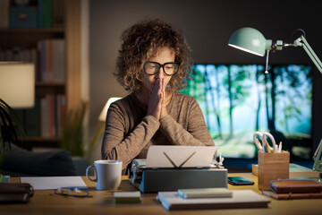 Creative writer working in her home office with a typewriter