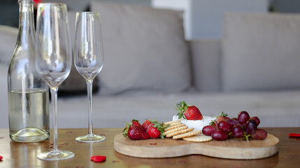 Wine glasses and fruit platter on table creating elegant celebration atmosphere