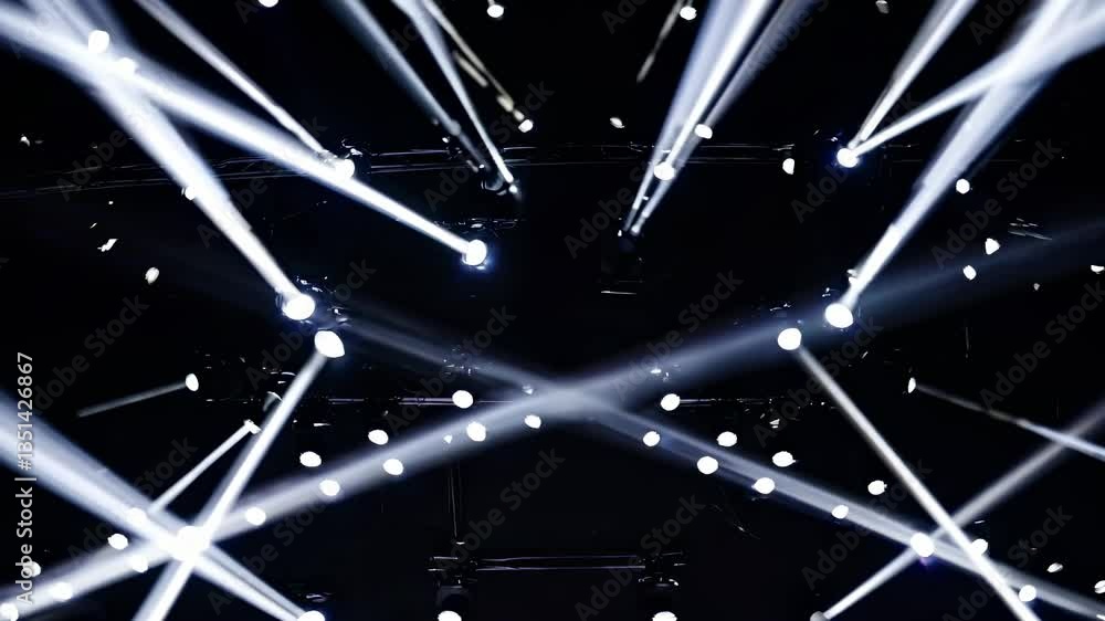 Aufkleber dynamic video scene with a low-angle view of bright spotlights piercing a dark space, creating a dra