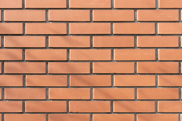 Red brick wall with a classic pattern, creating a strong and industrial look. Perfect for backgrounds, textures, and architectural projects.