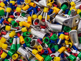 Colorful assortment of electrical connectors scattered on a surface in a workshop environment