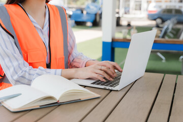 Construction Supervisor: A diligent construction supervisor in a safety vest, engrossed in work on...