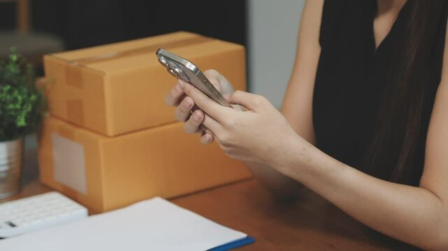 businesswoman start small business and successful SME entrepreneurs asian woman hoding boxs works from home delivering parcels online. SME delivery concept and packaging