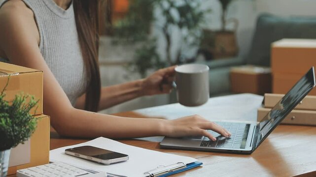 businesswoman start small business and successful SME entrepreneurs asian woman hoding boxs works from home delivering parcels online. SME delivery concept and packaging