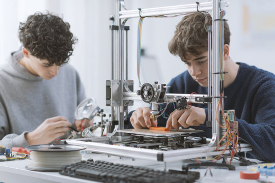 Students learning how to use a 3D printer in the lab
