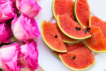 bouquet of pink roses on the table with watermelon
