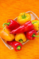 yellow and red peppers closeup on orange napkin
