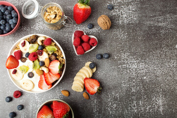 Muesli with organic berries and nuts. Oat muesli with raspberry, blueberry, strawberries, kiwi, almond, cashew, banana. Healthy food, top view