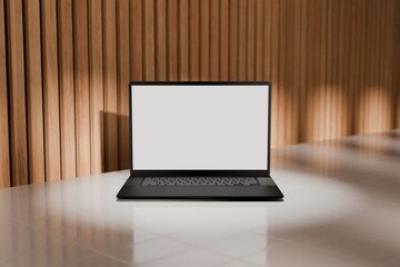 High end laptop on tile studio floor and acoustic backdrop. Blank mockup template screen. Spotlight from above