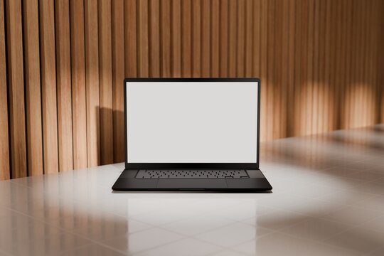 High end laptop on tile studio floor and acoustic backdrop. Blank mockup template screen. Spotlight from above