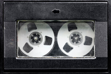 Inside the cassette door is a compact cassette with a reel-to-reel look