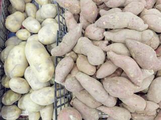 potatoes, onions, sweet potatoes on the grocery counter