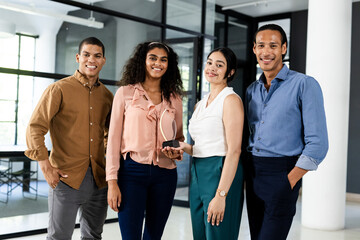 Diverse business team smiling confidently while holding award in modern office