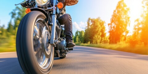 Naklejka premium A man is riding a motorcycle on a road. The motorcycle is black and the man is wearing a leather jacket