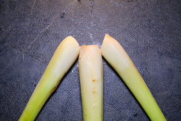 Closeup of three lemongrass stalks. Isolated lemongrass stem which functions as an aromatic with...