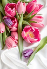 Obraz premium Delicate pink and violet tulips arranged on pristine white silk, art, hue, tone