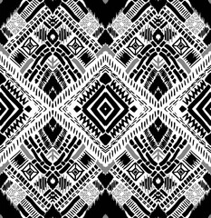 Fototapeta premium Monochrome tribal echoes pattern. Seamless, ethnic design with geometric patterns in black, white, and grey. Perfect for fabric, prints, & more.