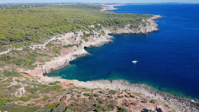 Spectacular Aerial Drone Footage of Breathtaking Salento Coast in Porto Selvaggio, Puglia, Italy Featuring Ancient Coastal Tower, Crystal-Clear Turquoise Waters, Rugged Limestone Cliffs.