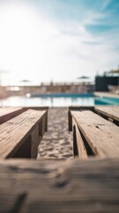 Obraz premium Wooden deck with blurred swimming pool background