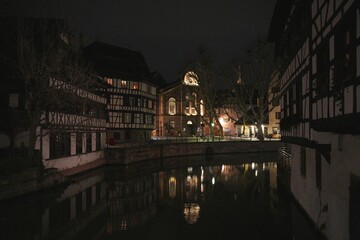 Canal reflections and timbered houses in Strasbourg at night