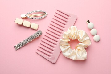 Different hair accessories on pink background, flat lay