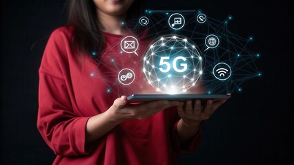 5G network. Woman in red sweater holds tablet displaying a glowing 5G sphere with digital icons, against a dark background. The image emphasizes