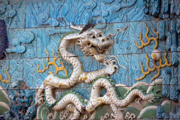 Detailed view of a dragon relief on the Nine-Dragon Wall at the Forbidden City in Beijing, China