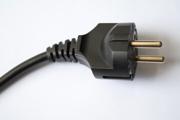 Electric European plug on a white background. The concept of saving electricity or charging. Black power cable with plug. 