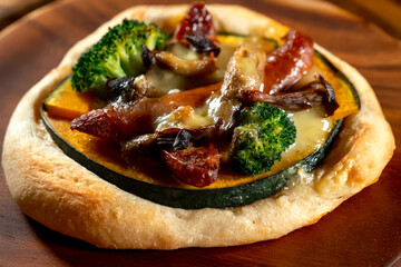 野菜とキノコとチーズのフォカッチャ　木製ボードの背景