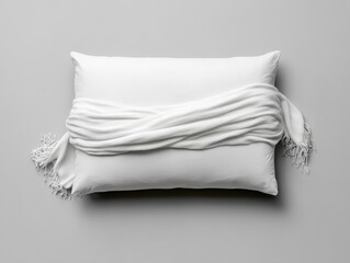 Elegant white pillow with a soft scarf draped.