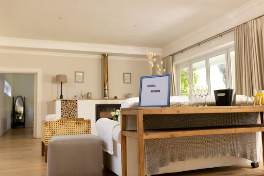Cozy living room with school reunion sign, ready for gathering, at home