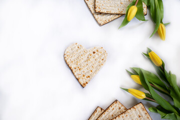 Layout of Traditional Matzah shape of heart prepared for Passover with on white background with...