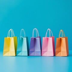 Colorful shopping bags in pastel tones on vibrant blue background for retail promotions, e-commerce visuals, or seasonal sales campaigns