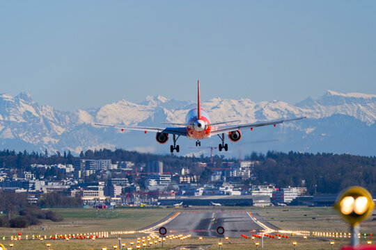 Easyjet passenger airplane Airbus A319-111 registration G-EZANC landing at Swiss Airport Z&uuml;rich Kloten on a sunny late winter day. Photo taken March 19th, 2025, Zurich Kloten, Switzerland.