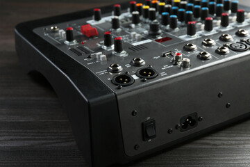Professional mixing console on wooden table, closeup