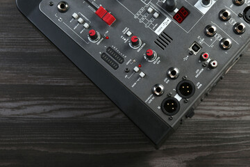 Professional mixing console on wooden table, top view. Space for text