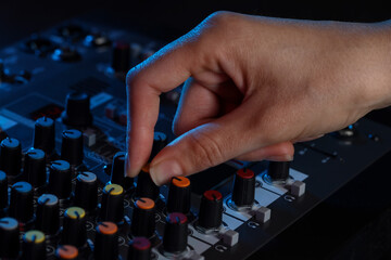Woman working with professional mixing console at table, closeup