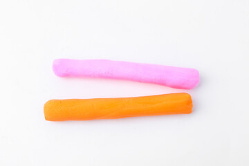 Colorful play dough on white background, above view