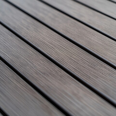 A medium close-up shot of WPC terrace planks viewed from approximately one meter above, showing the alignment, surface texture, and realistic wood grain of the composite material