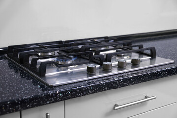 Stove with burners on counter in kitchen