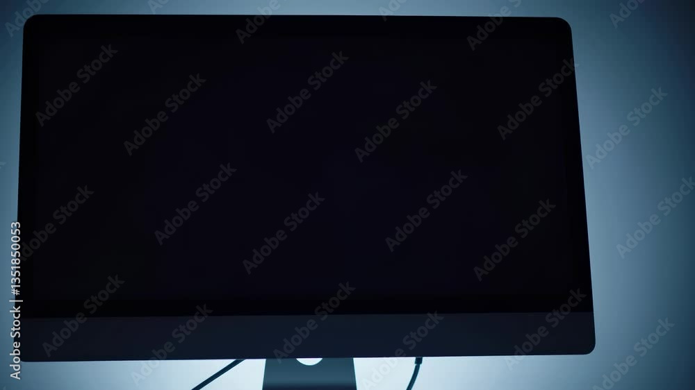 Poster a close-up, low-angle shot of a glowing computer screen in a dimly lit room, creating a mysterious, 