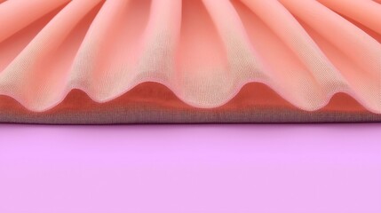 Soft peach fabric folds elegantly on a lilac background, showcasing its texture and gentle curves