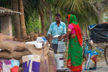 A woman collecting ration from the ration distributor